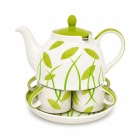 Zesdelig keramisch theeservies met witte theepot, groene details, bladmotief, twee kopjes en bijpassende schaal.