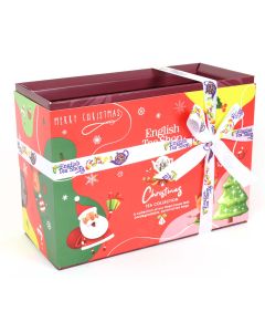 Feestelijke kerstcadeau giftbox van English Tea Shop met 12 biologische theezakjes in piramidevorm, versierd met lint en kerstillustraties.